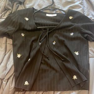 Tie top. Black with white and purple flower detail.